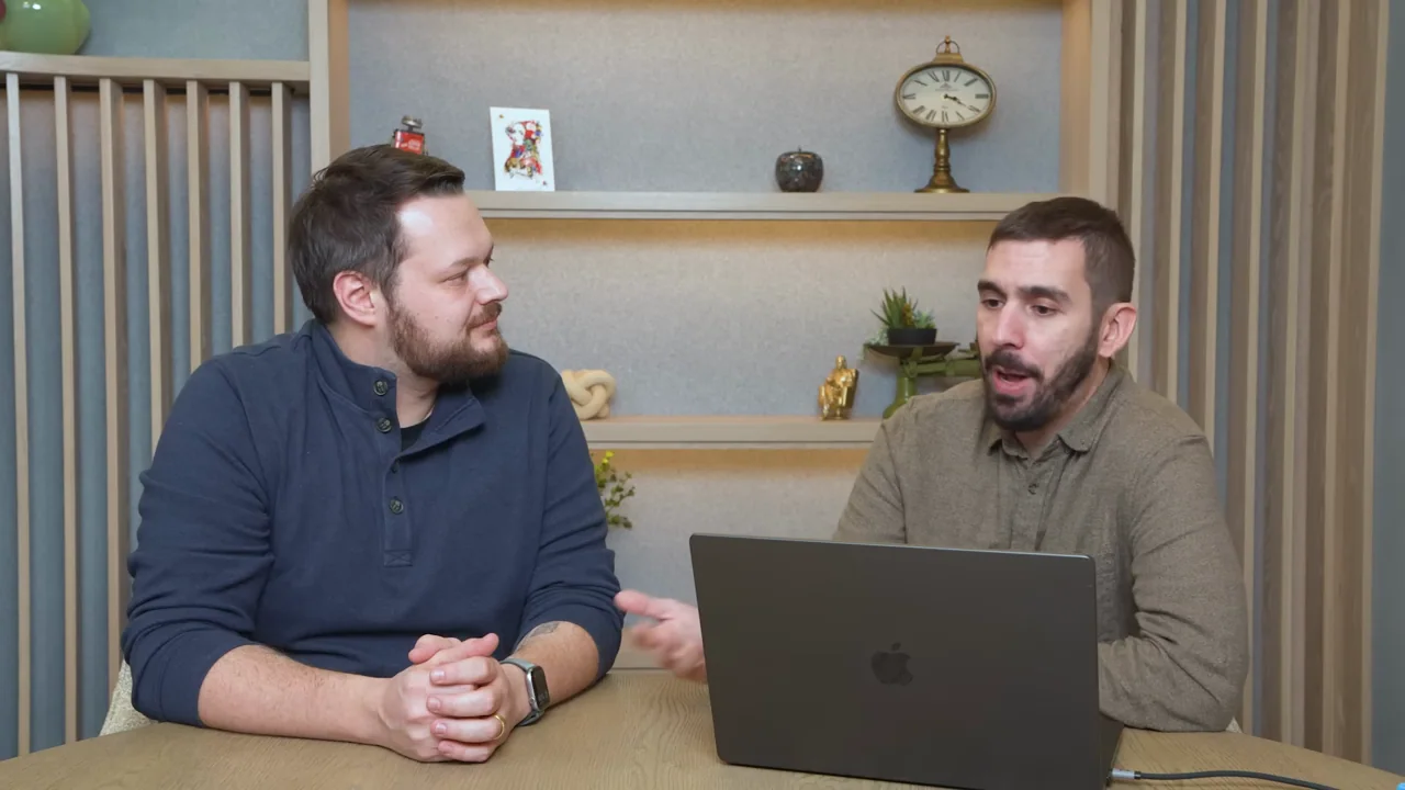 Close speaker coverage alternates with a two-person desk shot.