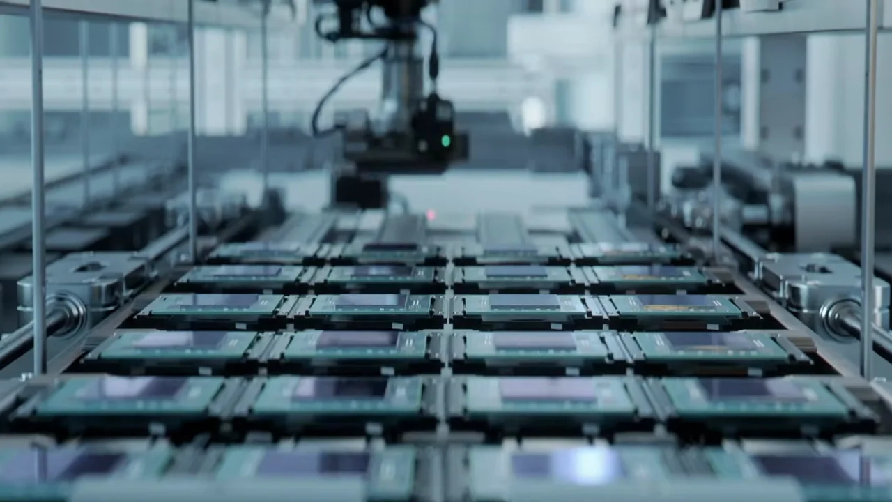 Interview and city coverage lead to semiconductor manufacturing imagery.