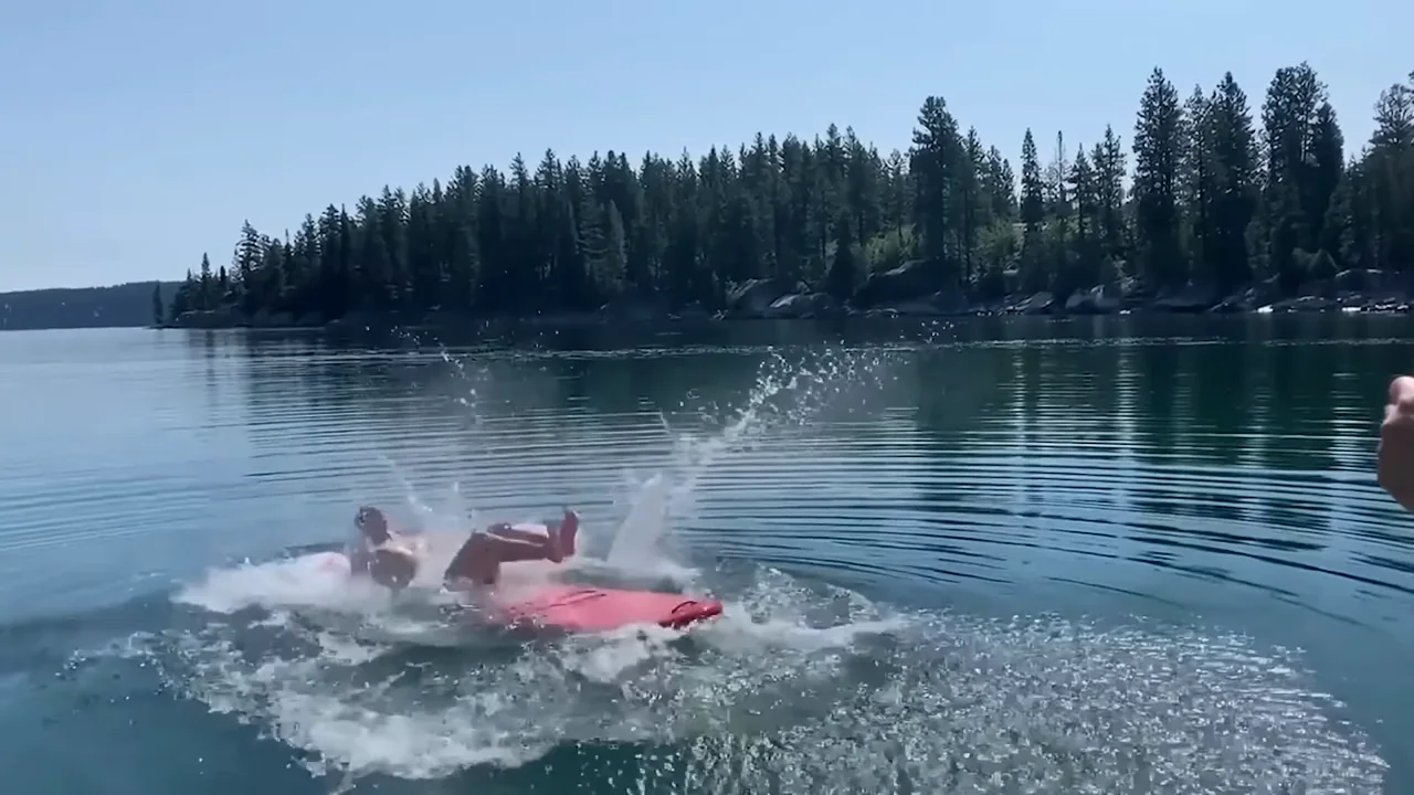 A person on a board, a splash, and a return to the board form a short action sequence.